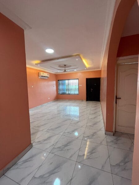 The living room boasts a stylish design, with a soft arch leading to other rooms and modern lighting.