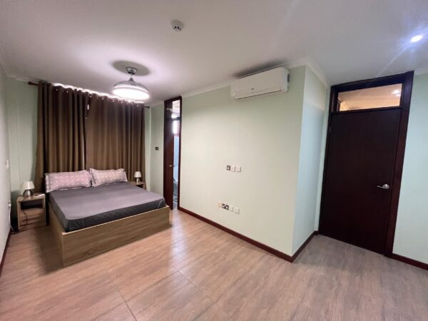 Master bedroom with a double bed, built-in wardrobe, and air conditioning.
