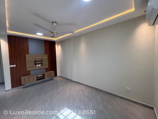 Living area designed with a dedicated entertainment wall section.