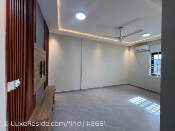Living area designed with a dedicated entertainment wall section.