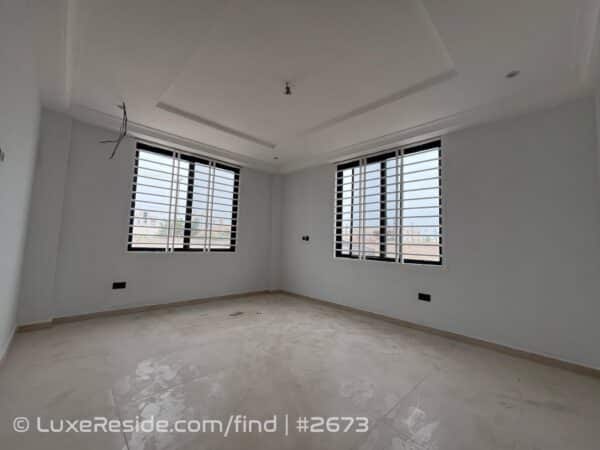 Spacious bedroom area featuring large windows for natural light and a stylish POP ceiling.