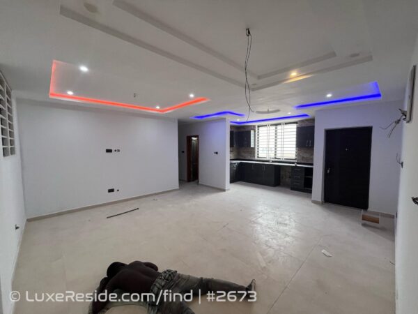 Bright room space, suitable as a bedroom or living area, featuring secure windows and modern lighting.