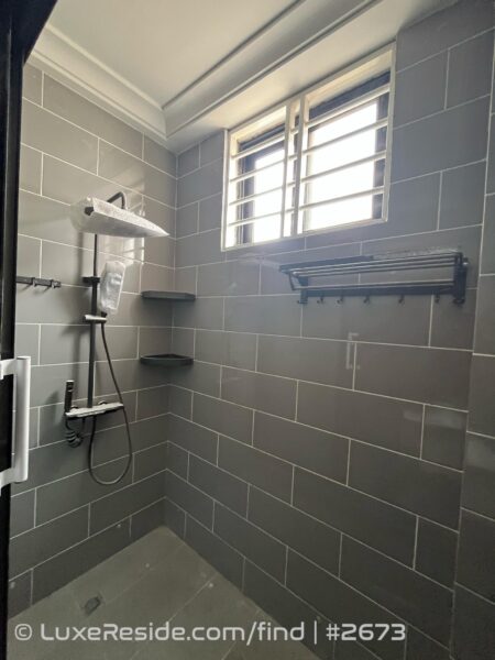 Detail of the walk-in shower, complete with shelving and modern fixtures.