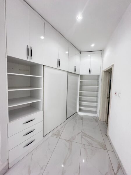 Ample storage space in the built-in wardrobes with a sleek wooden finish.