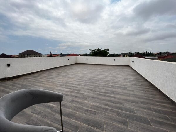Expansive rooftop terrace with panoramic views of the neighborhood, ideal for outdoor gatherings or simply enjoying the view.