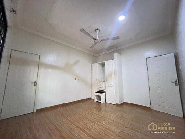 Large living room with tiled floors, and ceiling fan.