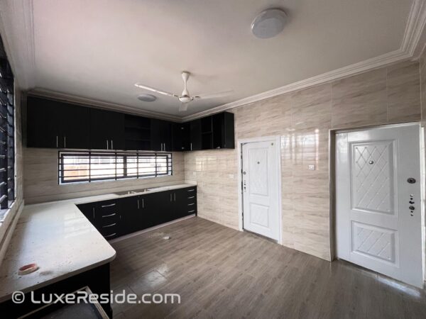 Fully fitted kitchen with sleek cabinets and ample storage.