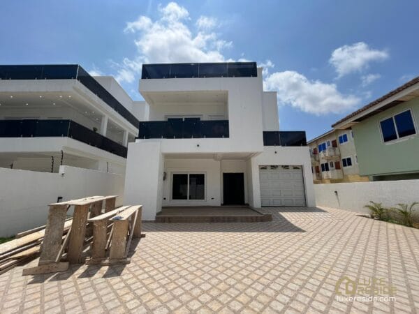 Front view of the house, showcasing its modern design and private garage.