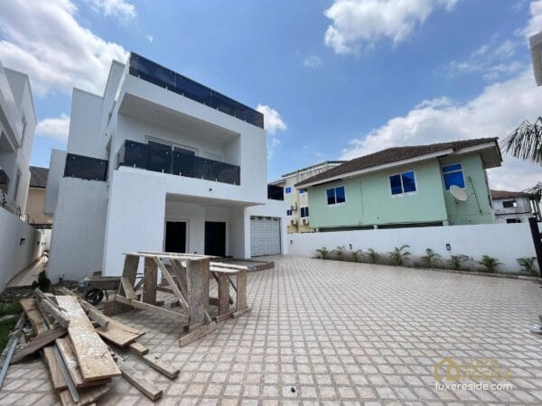 Front view of the house, showcasing its modern design and private garage.
