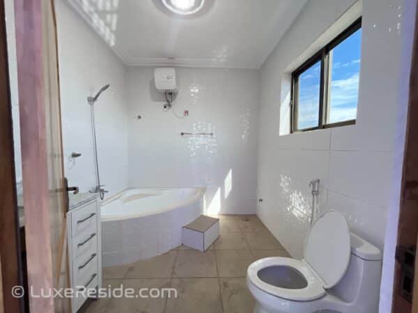 Relax in the elegant master bathroom featuring a luxurious tub.