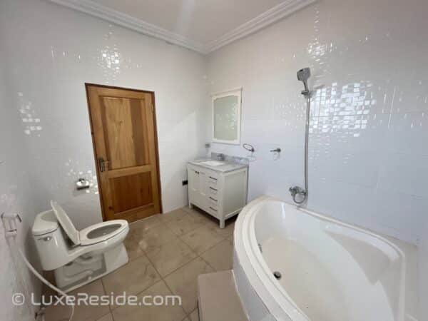 Relax in the elegant master bathroom featuring a luxurious tub.