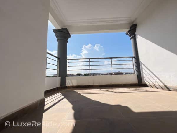 Enjoy your morning coffee with serene views from this spacious balcony.
