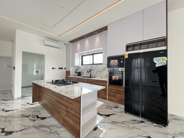 Gourmet kitchen featuring marble countertops, wood accents and premium appliances.