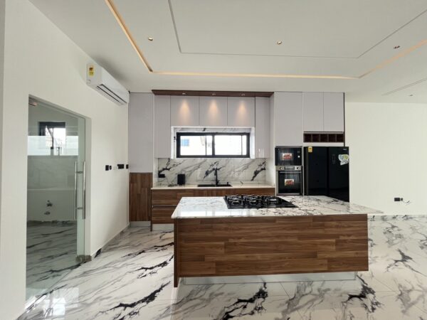 Gourmet kitchen featuring marble countertops, wood accents and premium appliances.