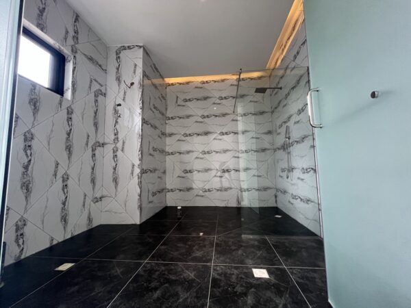 Ensuite master bathroom with high-end finishes and spacious walk-in shower.