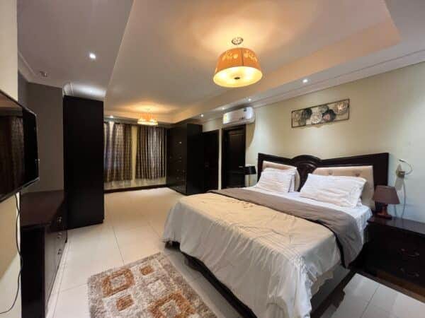 A cozy master bedroom with ample wardrobe space and stylish lighting.