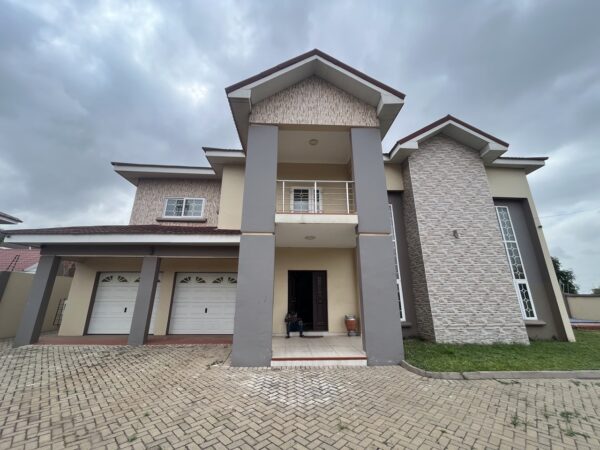 Impressive facade with a two-car garage, a balcony, and stylish architectural details.