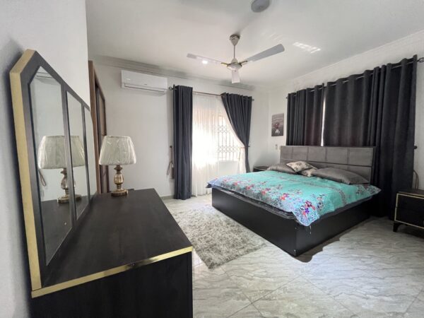 Expansive bedroom with elegant finishes and large windows for natural light.