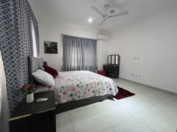 Expansive bedroom with elegant finishes and large windows for natural light.