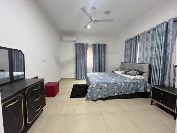 Expansive bedroom with elegant finishes and large windows for natural light.