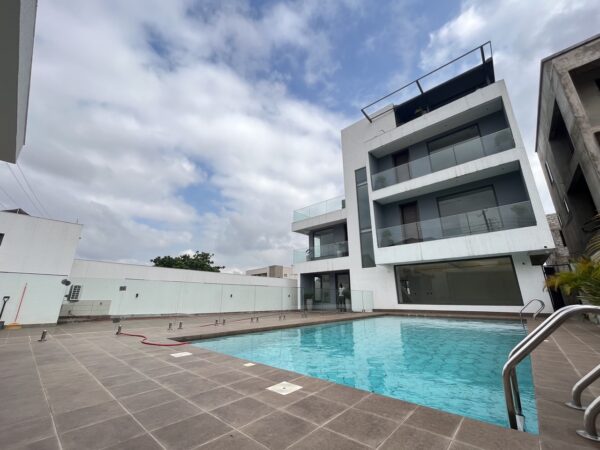 Modern architecture with a large pool area, perfect for outdoor relaxation.