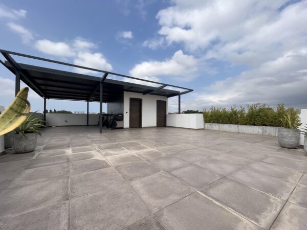 Spacious rooftop terrace with a bar and kitchenette, ideal for entertaining.