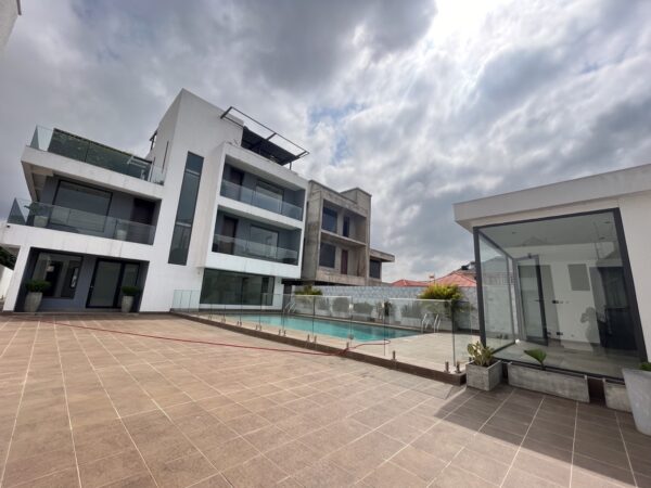 Modern architecture with a large pool area, perfect for outdoor relaxation.