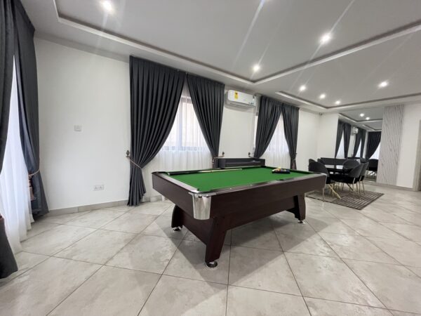 Open living area with pool table, perfect for entertaining guests.