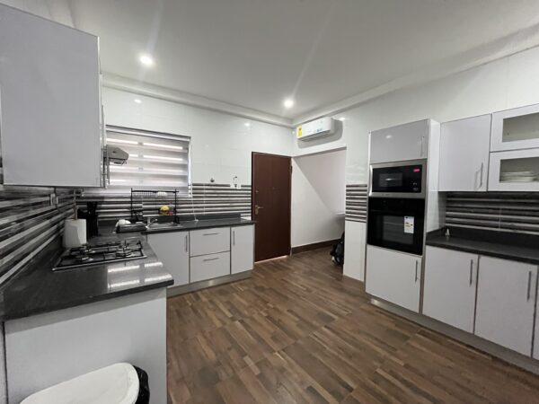 Contemporary kitchen with modern appliances, including a washing machine.