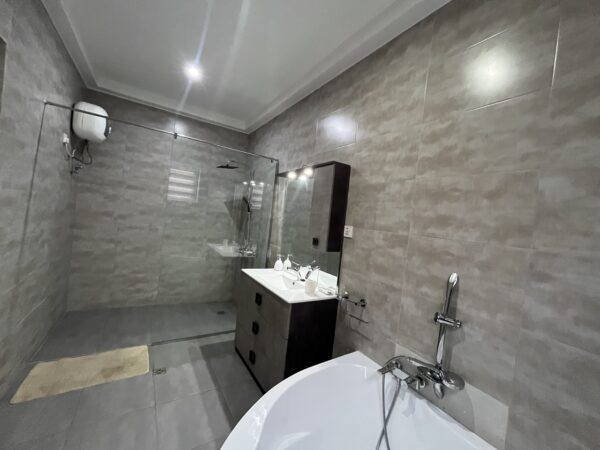 Sleek en-suite bathroom with a walk-in shower and premium fixtures.