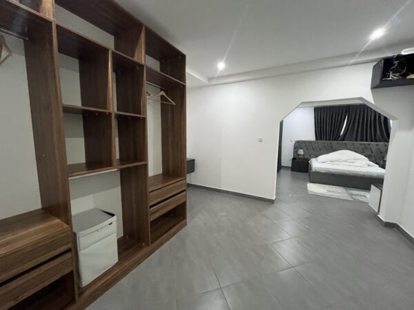 Walk-in closet with ample storage and sleek wooden design.