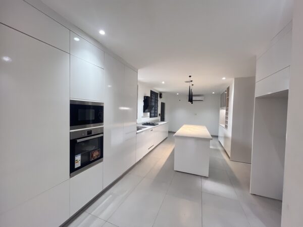 Fully equipped modern kitchen with an island and built-in appliances.