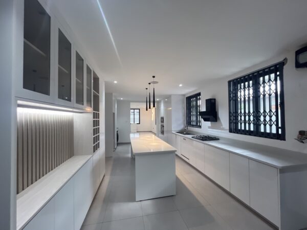 Fully equipped modern kitchen with an island and built-in appliances.