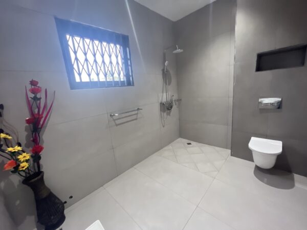 Modern bathroom featuring elegant fixtures and a spacious design.