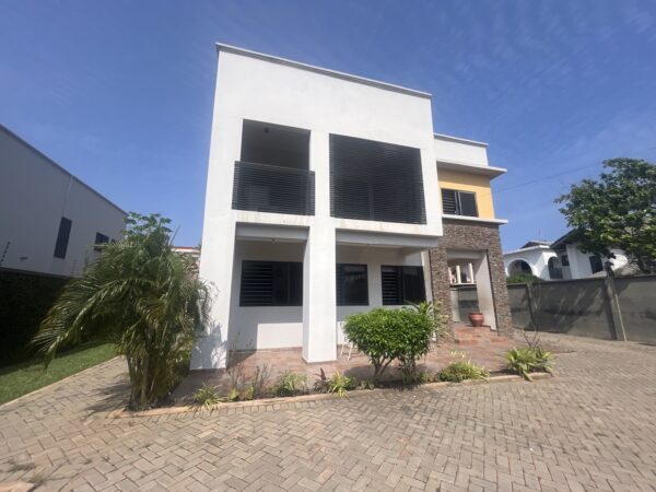 Spacious compound with well-kept lawn and ample parking space.