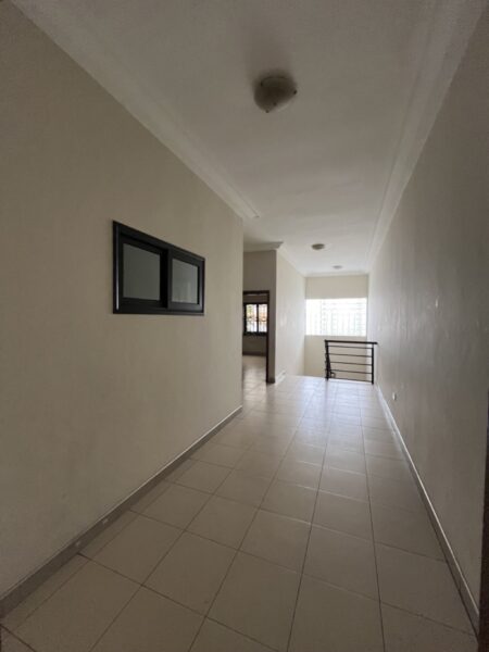 Spacious hallway with tiled floors leading to the bedrooms and living areas.