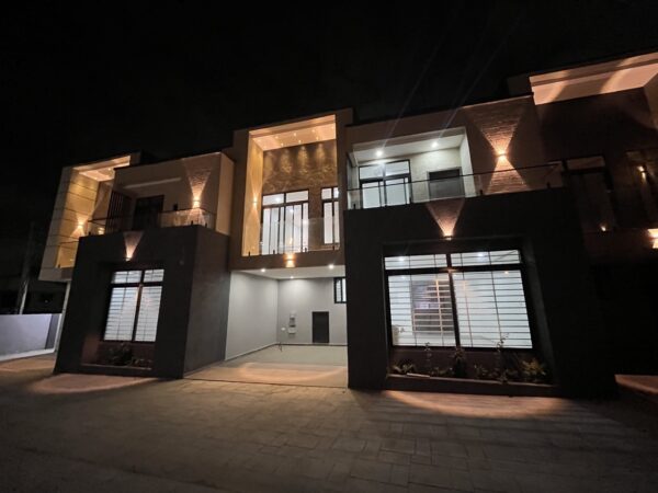 Stunning townhouse exterior with ambient lighting that highlights the architecture.