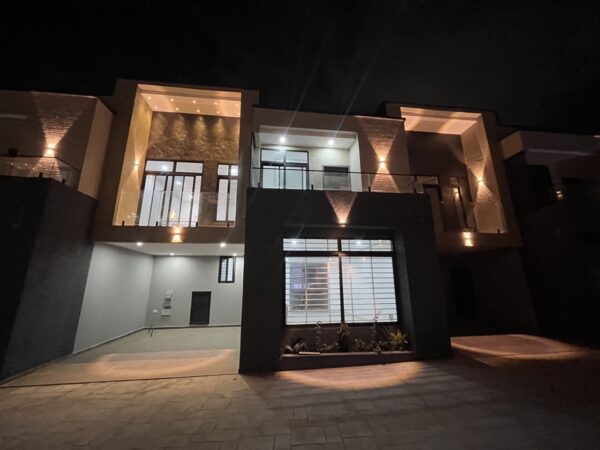 Stunning townhouse exterior with ambient lighting that highlights the architecture.