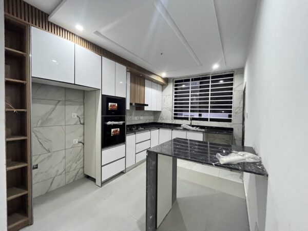 Sleek kitchen equipped with granite countertops and all modern amenities.