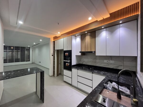 Sleek kitchen equipped with granite countertops and all modern amenities.