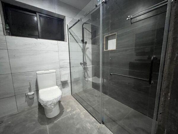 Chic bathroom design with a glass-enclosed shower and premium fixtures.