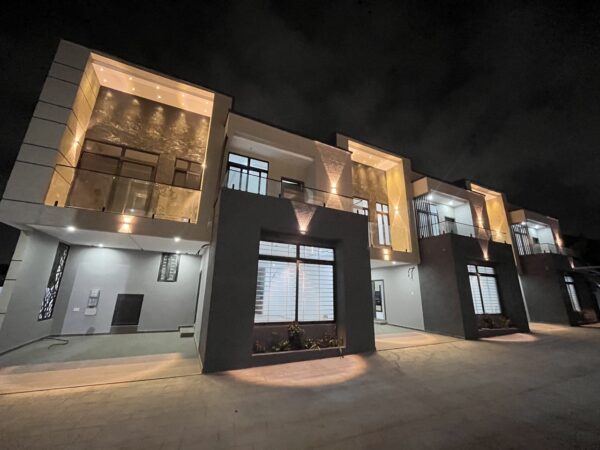 Stunning townhouse exterior with ambient lighting that highlights the architecture.
