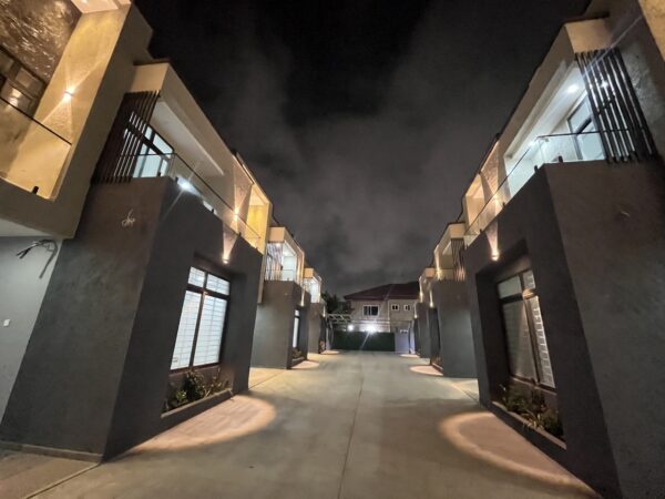 Stunning townhouse exterior with ambient lighting that highlights the architecture.