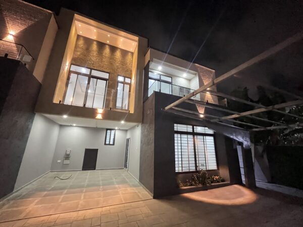 Stunning townhouse exterior with ambient lighting that highlights the architecture.