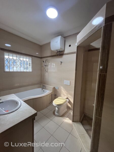 Master bathroom with a bathtub, shower, and vanity.