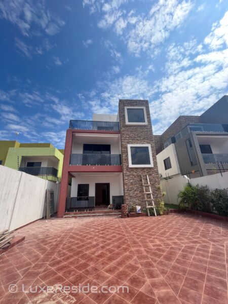 A striking contemporary façade with ample parking and secure fencing