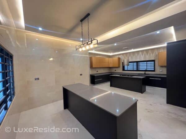 Modern kitchen with an island, built-in oven, and stylish lighting