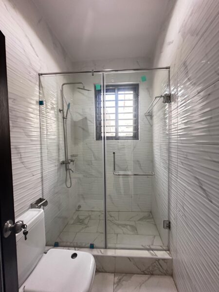 Sleek bathroom with stylish shower space and elegant tiles.